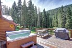 Black Bear Lodge deck with hot tub, grill and  picnic table. 